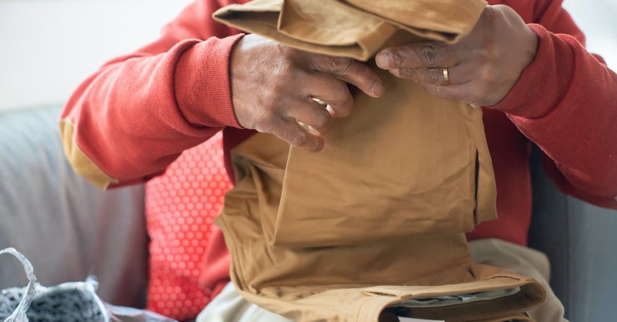 Buying second-hand winter clothes in northern China - Man in Brown Button Up Shirt and Beige Pants