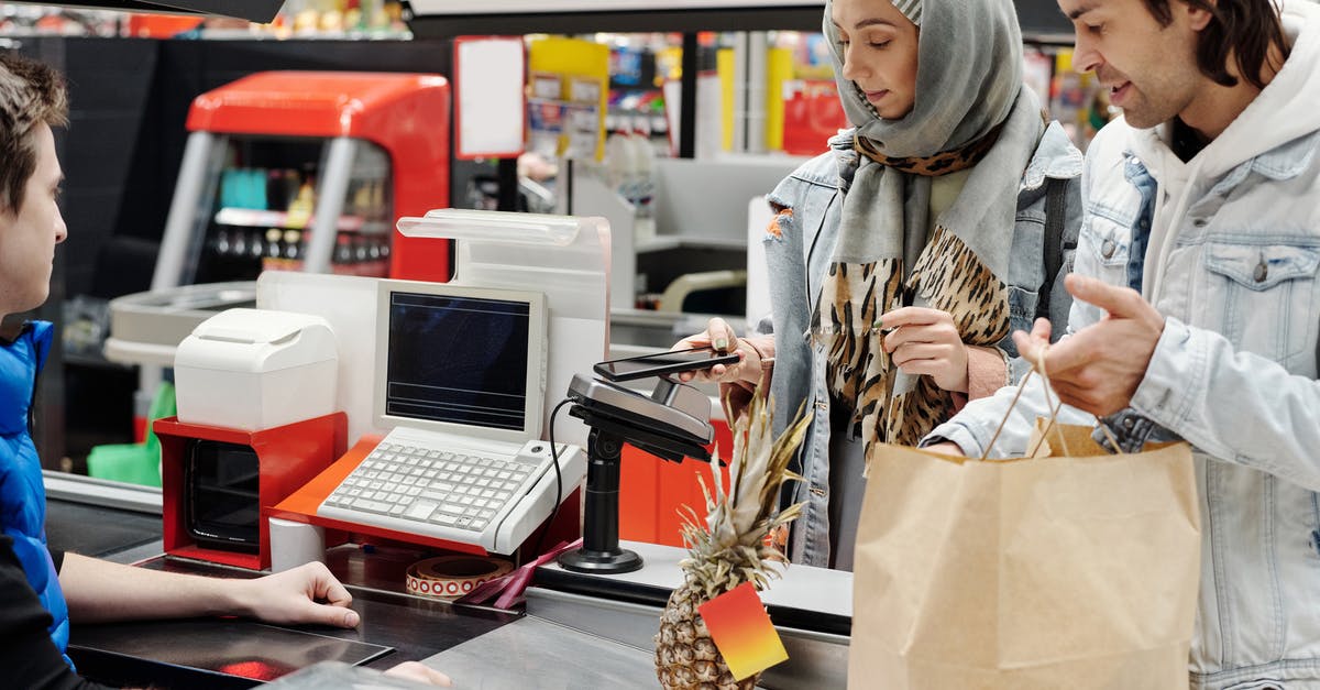 Buying smartphone in US and bringing back to Canada - Couple Buying Groceries at a Supermarket