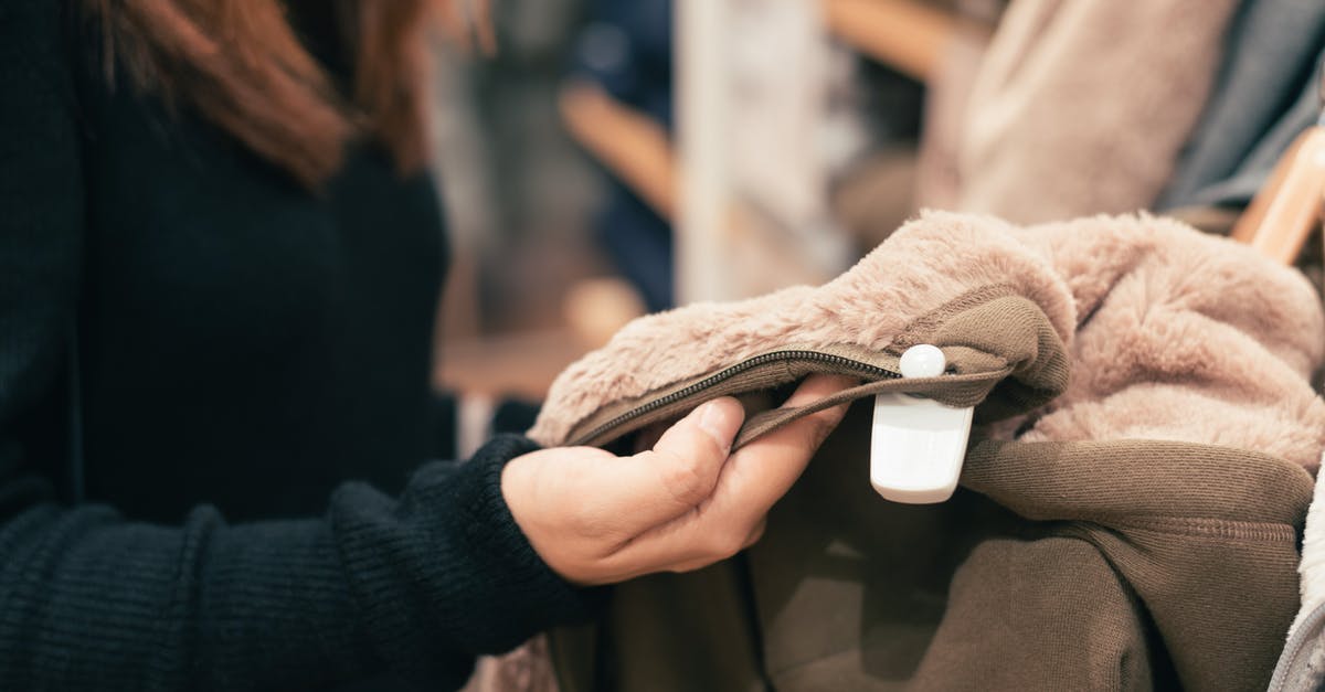 Buying tickets for New York Yankees game - Woman Wearing Black Sweater Holding Fleece Cloth