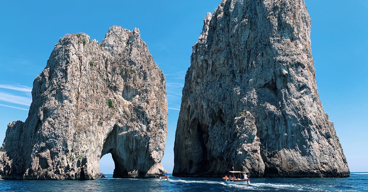 Campania Artercard from Pianura to Naples, Pompei, Vesuvius - White Boat Passing Stone Formations on Ocean