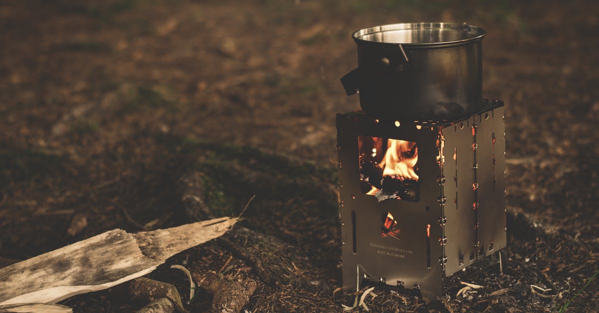 Camping stove on a plane? - Stainless Steel Pot on Brown Wood Stove Outside during Night Time