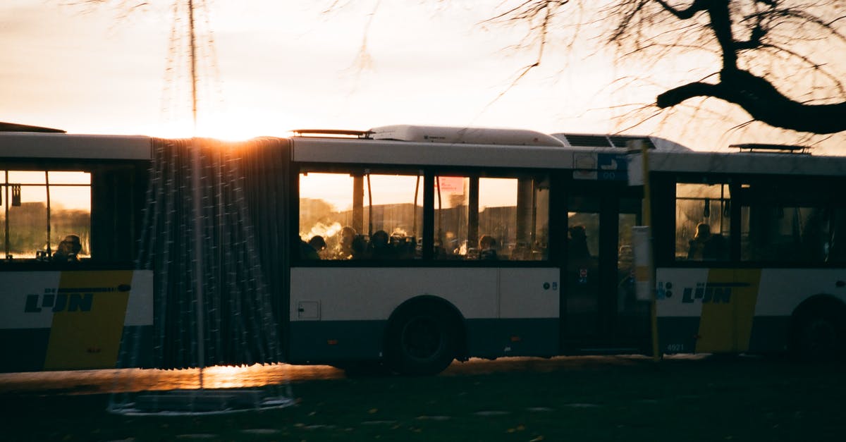 Can a 15-passenger van use the bus lane in Montreal? - Modern bus driving on road at sundown