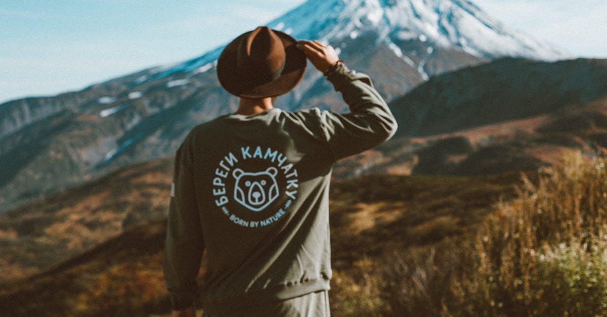 Can a 15-year-old travel alone to Russia from the USA? - Lonely man in hat admiring picturesque view