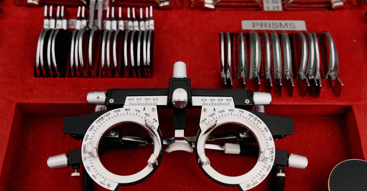 Can a BIVS visa holder visit Amsterdam for 2 days? - High angle collection of various trial lenses and frame placed in red holder in ophthalmology clinic