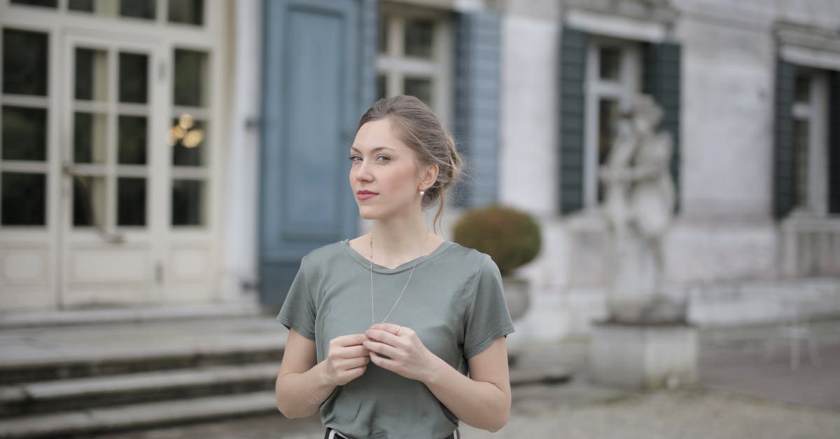 Can a child still visit the cockpit during flight? - Beautiful young woman standing near old building and looking at camera