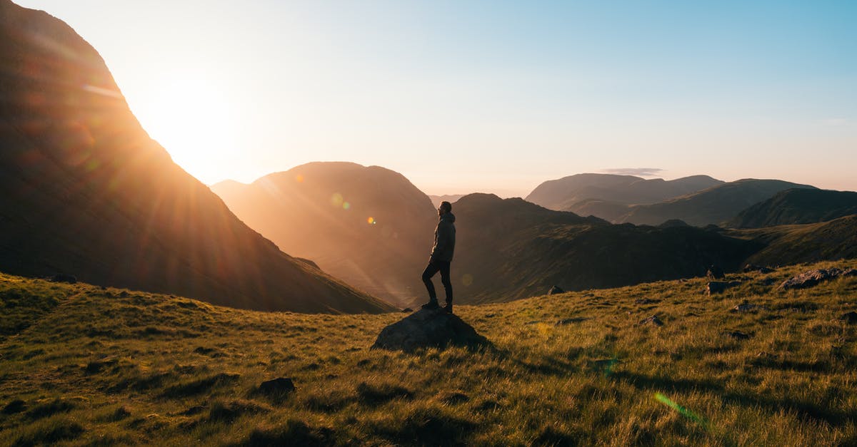 Can a dependant get a visa and travel alone to Schengen? - Silhouette Photography of Person Standing on Green Grass in Front of Mountains during Golden Hour