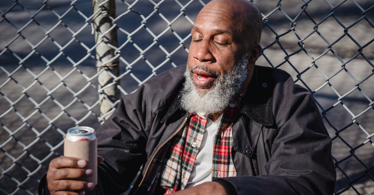 Can a dual citizen disregard border controls? - African American homeless man holding beer on street