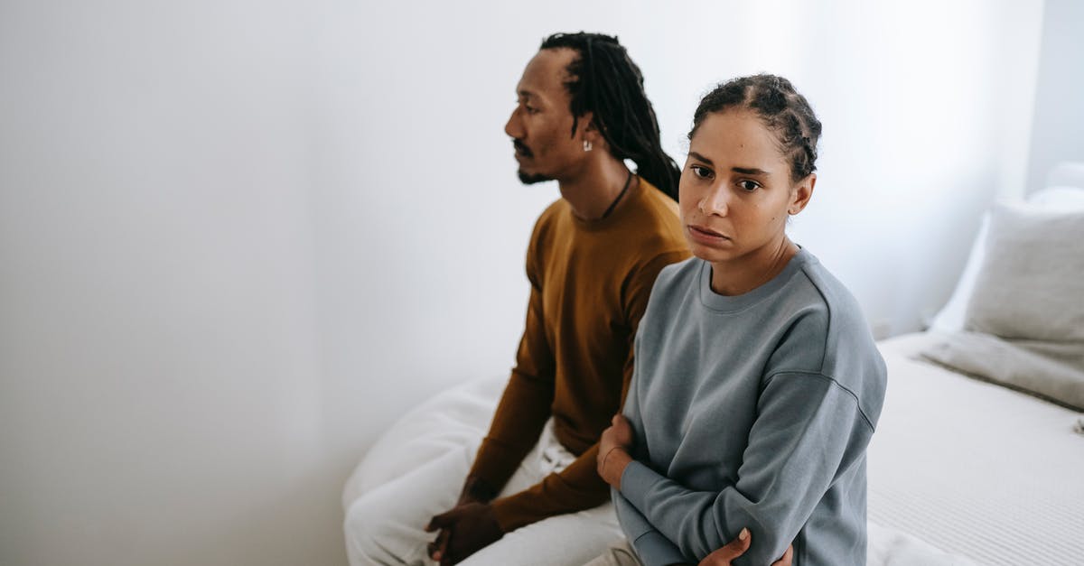 Can a husband and wife take Schengen visa appointments at separate centers? - Unhappy black couple sitting on bed together Can a husband and wife take Schengen visa appointments at separate centers? - Unhappy black couple sitting on bed together