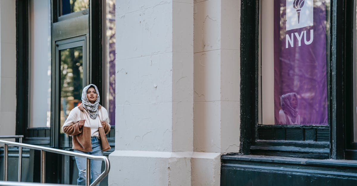 Can a Muslim woman visit Medina Mosques as tourist independently? - Trendy young Muslim woman walking on city street