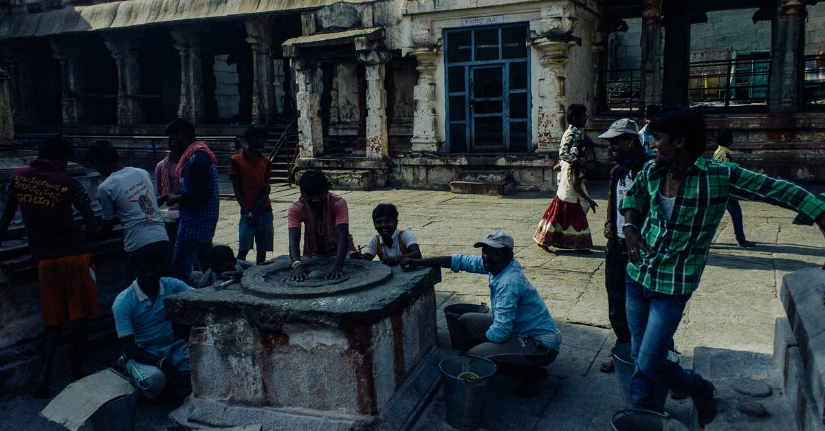 Can a Pakistani dual citizen visit Israel without any problems? - Asian people in casual clothes standing near and touching weathered religious stone wheel located in center of medieval historic Hampi village in India