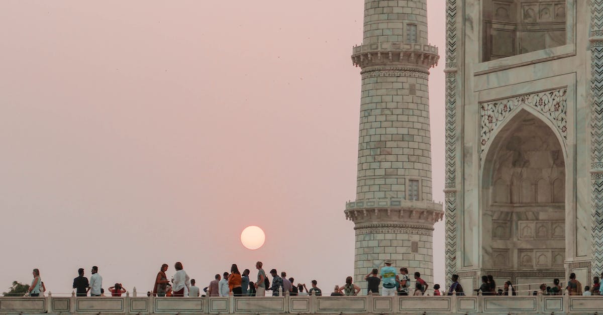 Can a person fly to the Moon as a tourist? - People on Concrete Building during Sunset