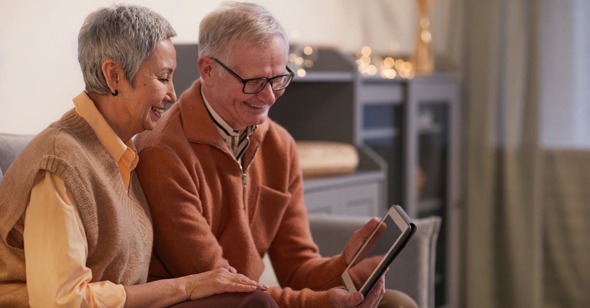 Can a Senior sit in a Handicap Seat on AMTRAK? - Couple Smiling While Looking at a Tablet Computer