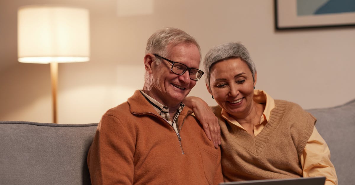 Can a Senior sit in a Handicap Seat on AMTRAK? - Man and Woman Sitting on Sofa While Looking at a Laptop