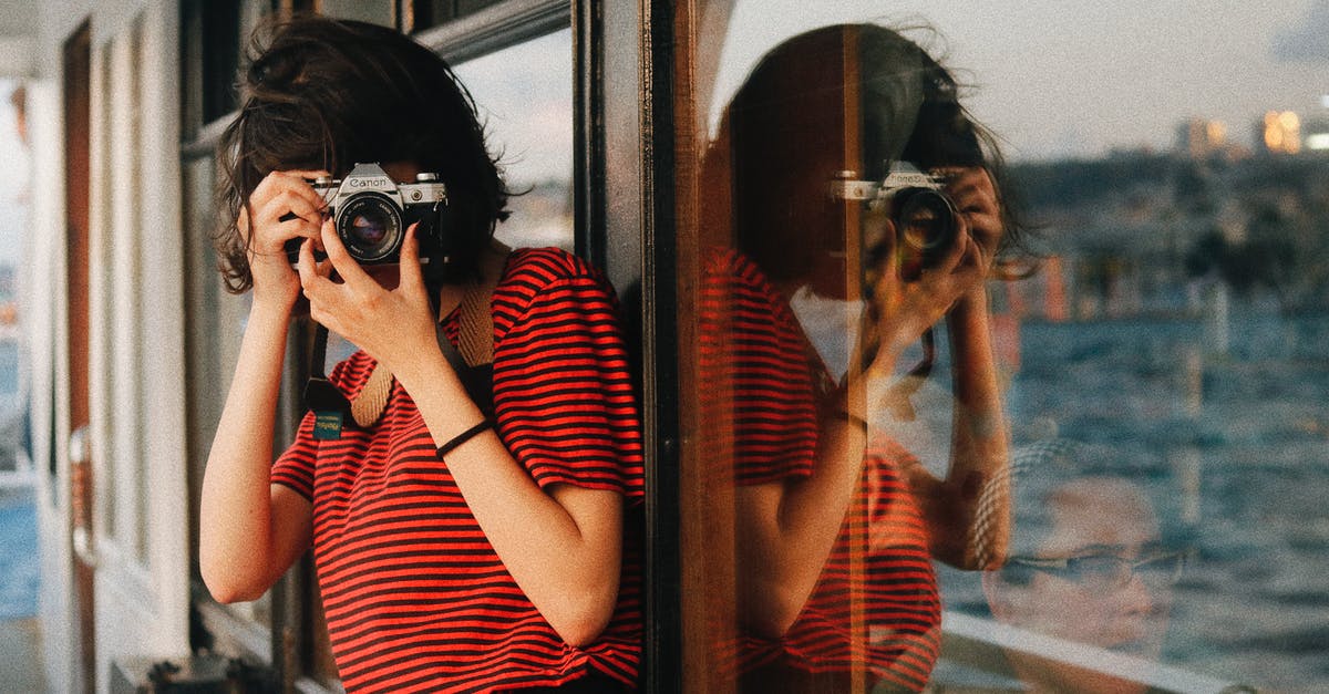 Can a tourist shoot a gun in the USA? - Woman in casual clothes standing near windows on ship deck while taking pictures on camera