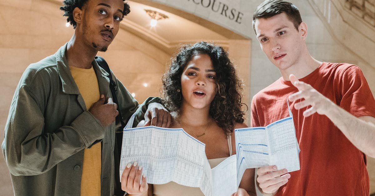 Can a Tunisian with a US A-2 visa visit Canada? [duplicate] - Amazed young multiracial male and female friends in casual outfits looking away while exploring map in Grand Central Terminal