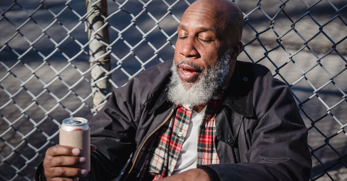 Can a twenty-year-old bring to the USA alcohol purchased legally in Spain? - African American homeless man holding beer on street Can a twenty-year-old bring to the USA alcohol purchased legally in Spain? - African American homeless man holding beer on street