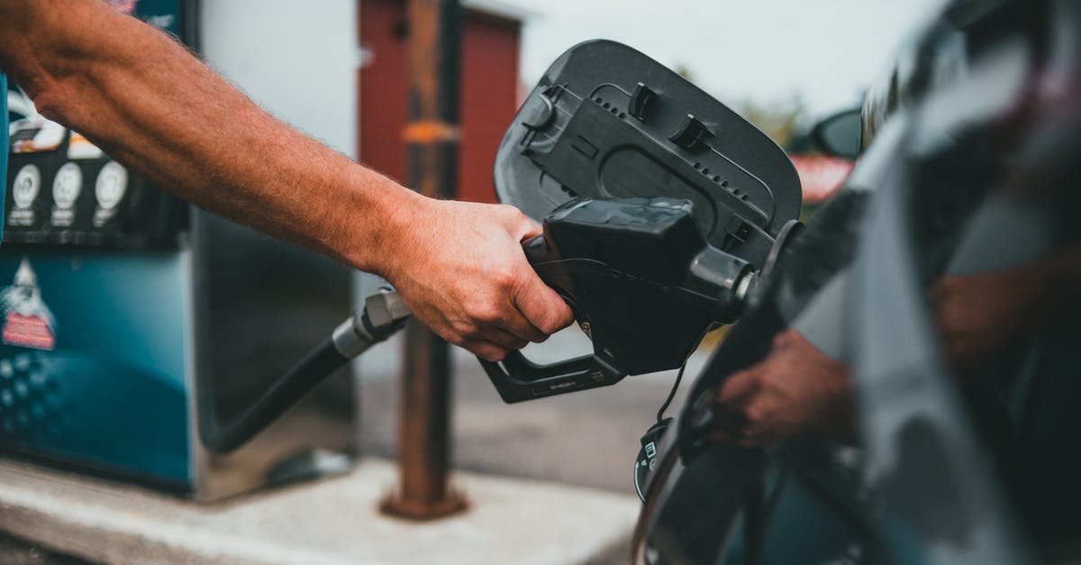 Can a WiFi station be hand luggage? - Person Putting Gasoline on a Vehicle