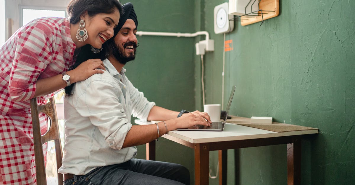 Can an Indian Tourist eVisa be used for Business [closed] - Happy young cuddling Indian couple using laptop during work at home