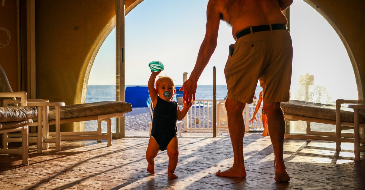 Can an infant travel anywhere on a parent's passport? - Adult man with toddler on resort