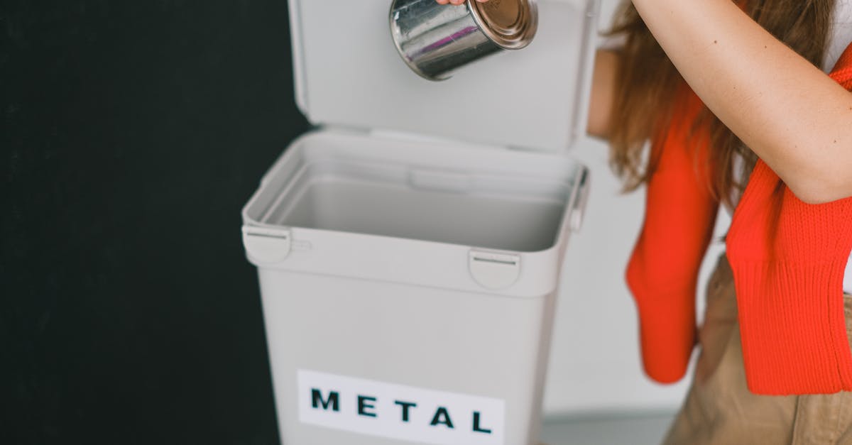 Can Dekko Silverfish paks be used in suitcases/luggage? - Woman sorting garbage and putting metal can into bucket