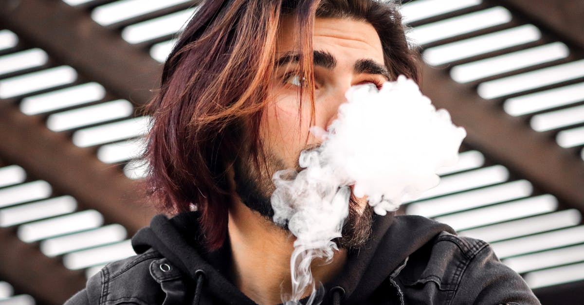 Can e-cigarettes / vaping set off smoke detectors? - A Man Puffing a Vape