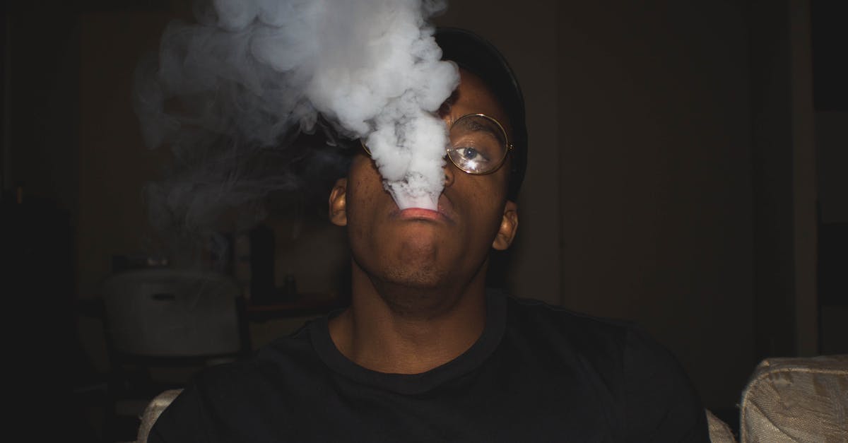 Can e-cigarettes / vaping set off smoke detectors? - Man Wearing Black Crew-neck Blowing Smoke