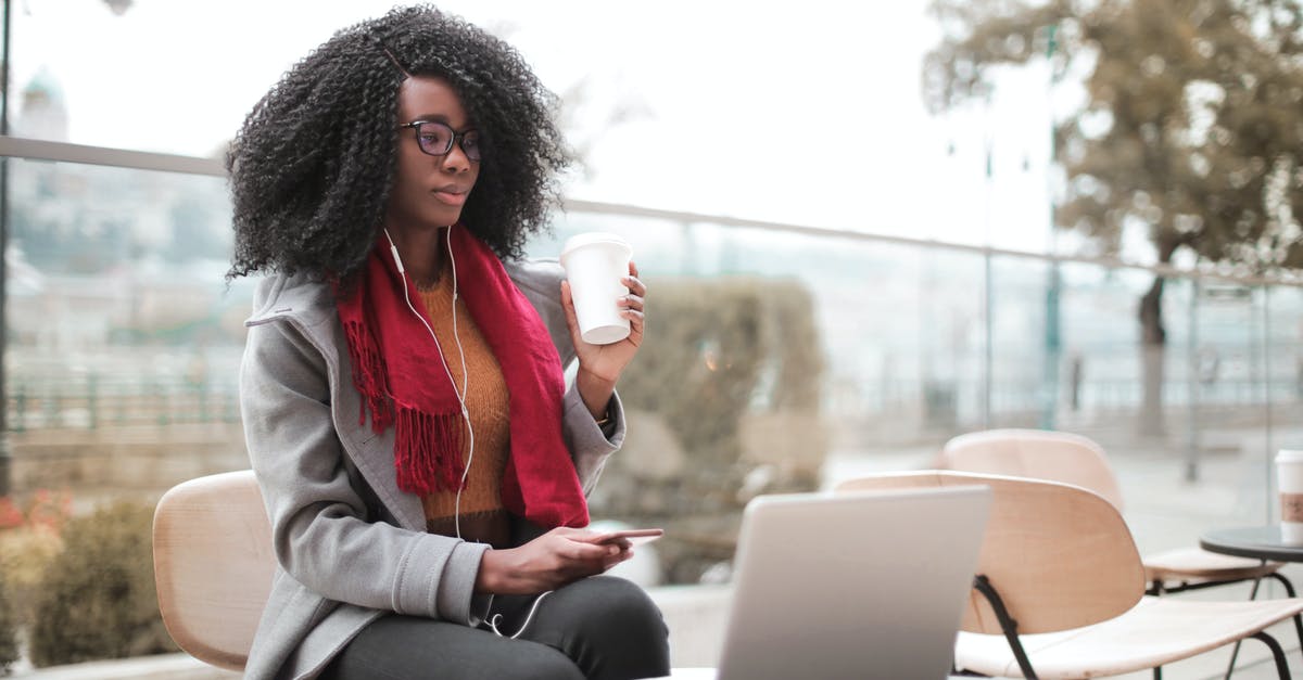 Can I access different business lounges? - Woman Drinking Coffee During Daylight