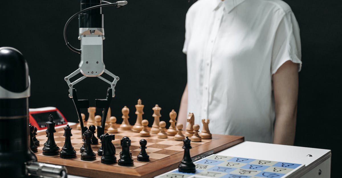 Can I accompany my mother-in-law until getting boarding passes at Heathrow? - A Robotic Arm Picking up a Chess Piece on a Chessboard