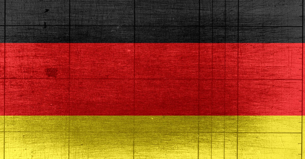 Can I be prosecuted in a European country while on vacation? - Grungy background designed as flag of Germany on shabby wooden board with measure scale