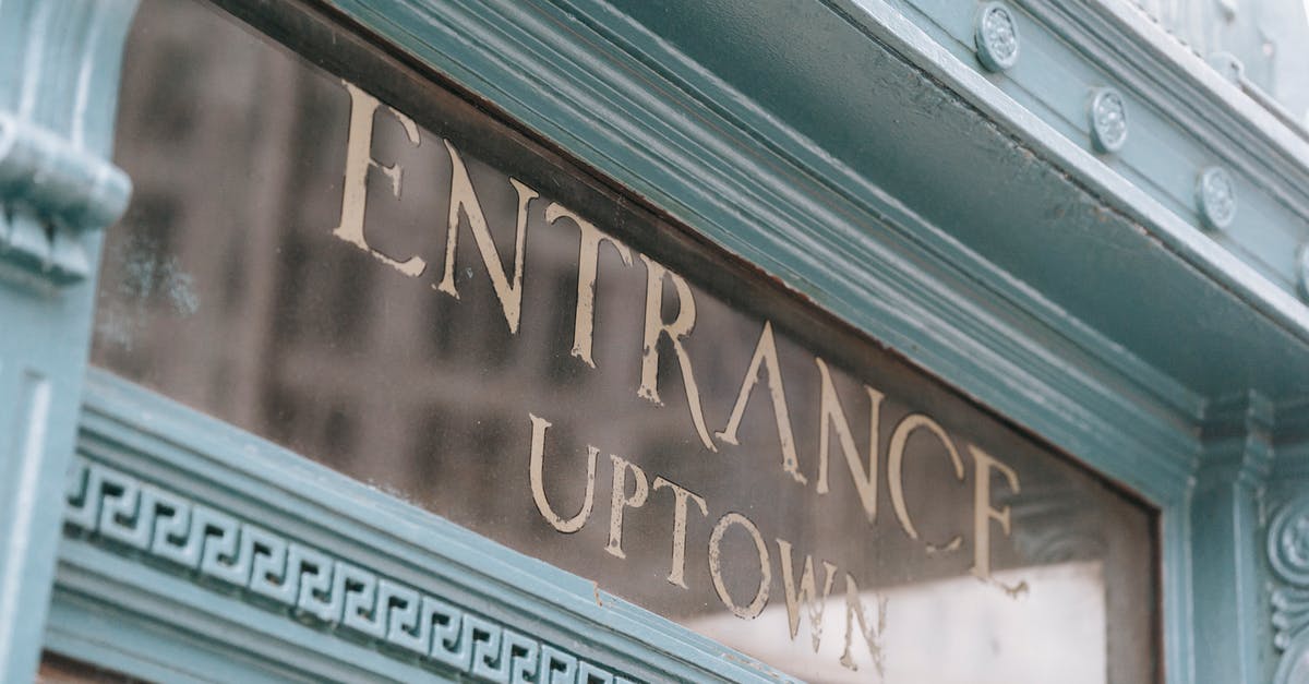 Can I be refused entry due to my place of birth? - Glass signboard with inscription placed in aged fashioned light blue facade of pub on street in daylight