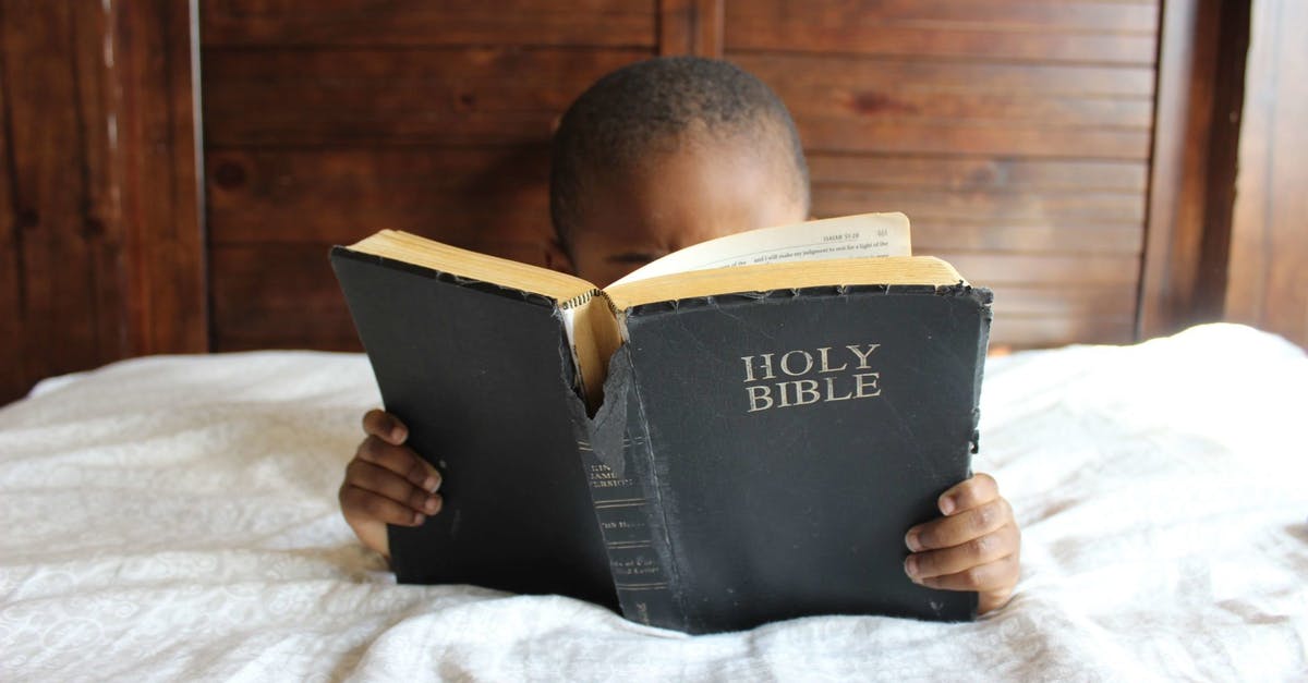 Can I book a seat for a suitcase? - Photo of Child Reading Holy Bible