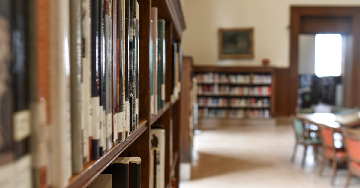 Can I book a seat for a suitcase? - Selective Focus Photography of Bookshelf With Books