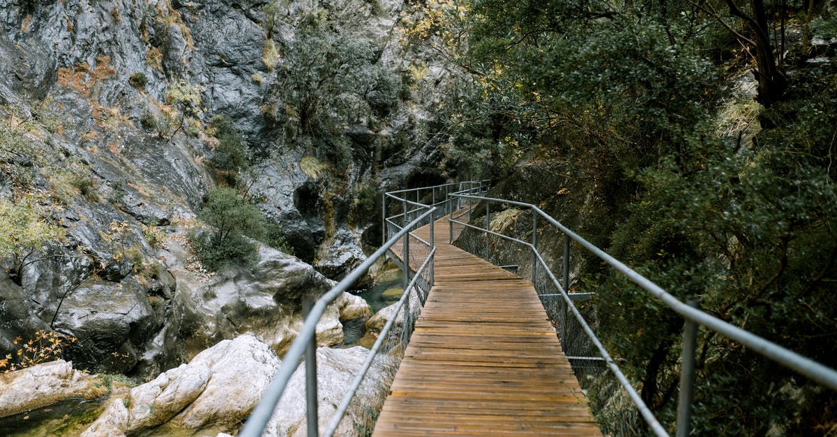Can I book two tickets to reach my destination with a stop over to my destination? [closed] - Small footbridge over river in mountainous terrain