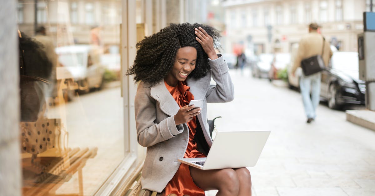 Can I bring a shoebox PC in my carry-on bag? - Woman in Gray Coat Sitting On Wooden bench