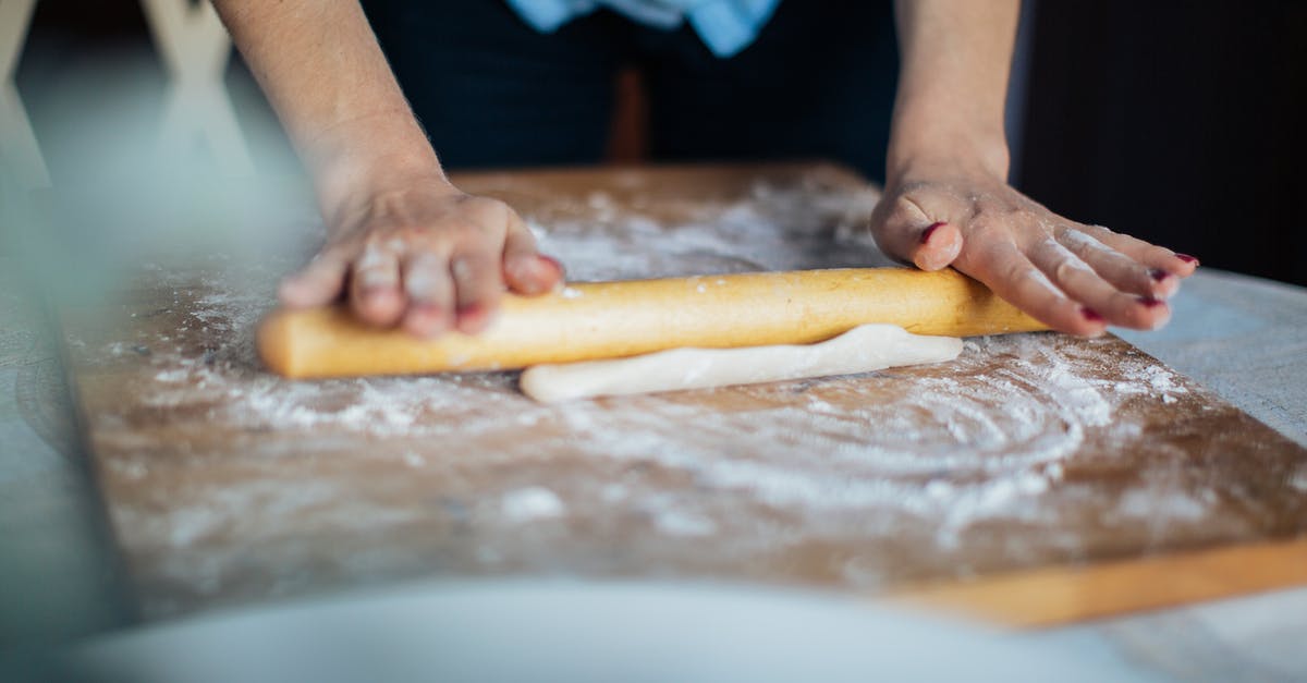 Can I bring a wooden dough rolling stick onto the plane(carry-on)? - Person Holding Brown Wooden Rolling pin