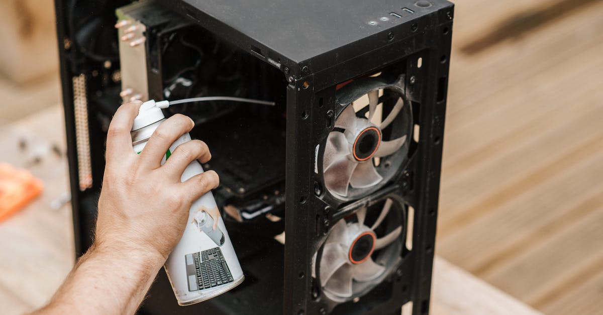 Can I bring compressed air cans in the airport? - Crop unrecognizable man cleaning computer system unit