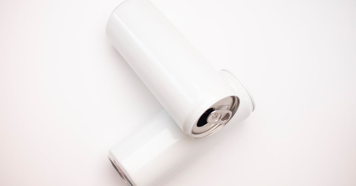 Can I bring compressed air cans in the airport? - White Cans on White Surface