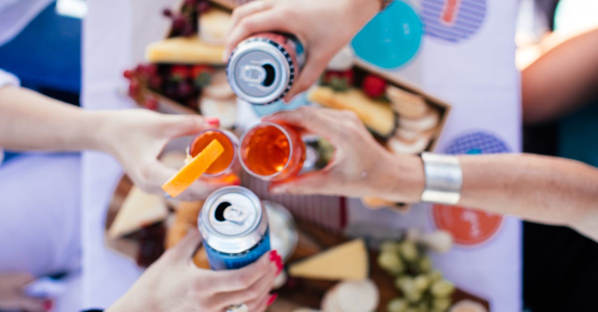 Can I bring glass goblets onboard? - Crop people clinking glasses over table