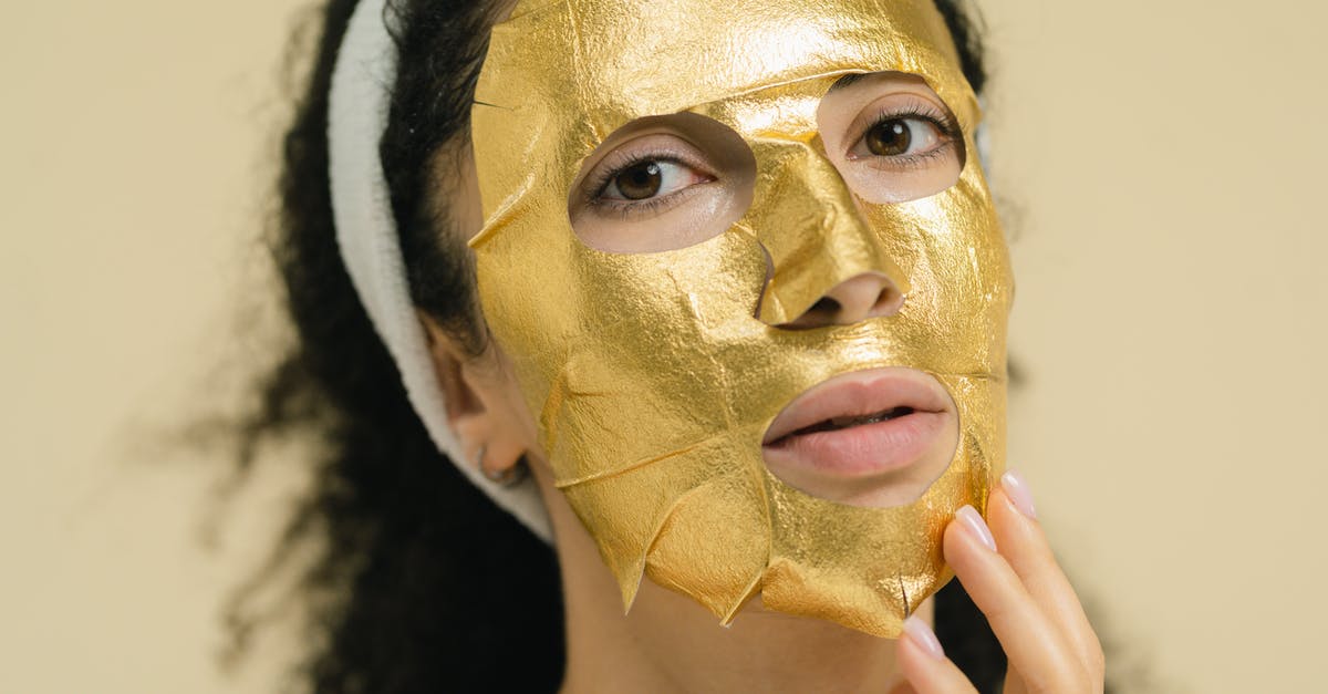 Can I bring gold sheet face masks in my carry on? - A Woman with a Gold Mask on Her Face