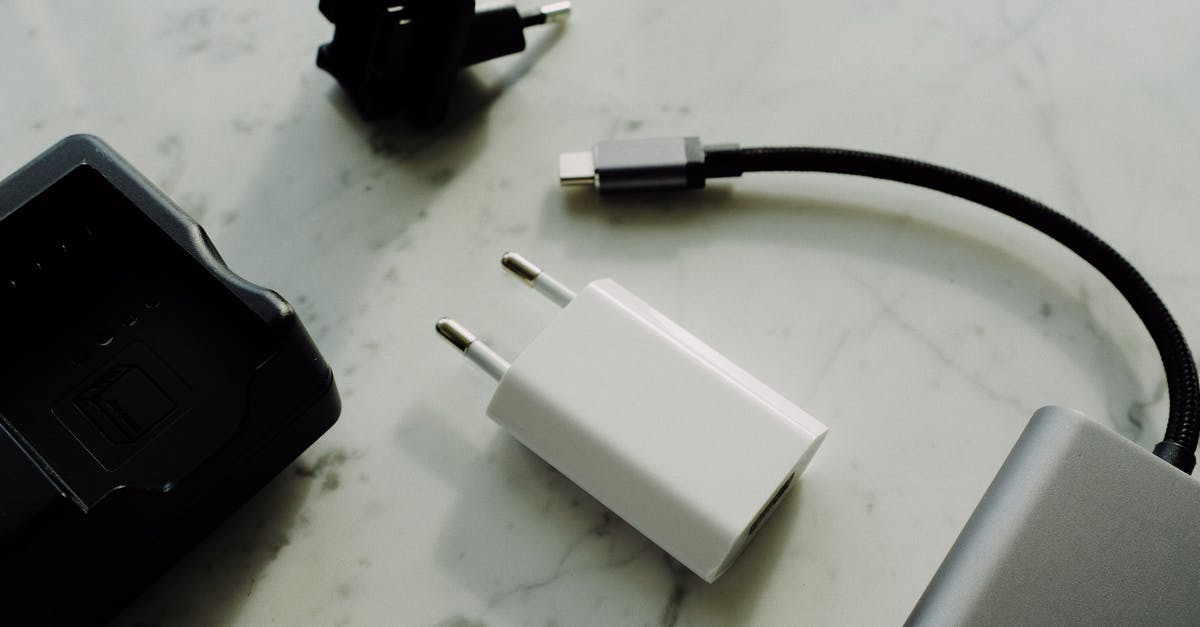 Can I bring my battery pack on the airplane that has variable voltage/wattage? - Composition of various modern electronic devices placed on white marble surface