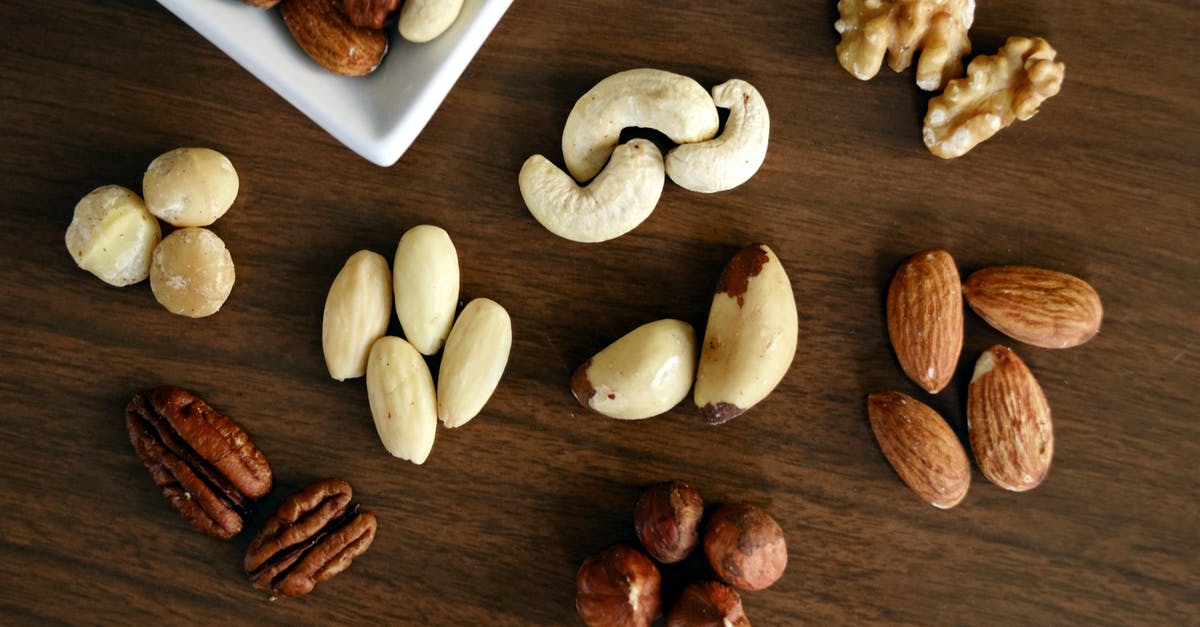 Can I bring nuts and cooked sausage from Brazil to Germany? - Variety of Brown Nuts on Brown Wooden Panel High-angle Photo