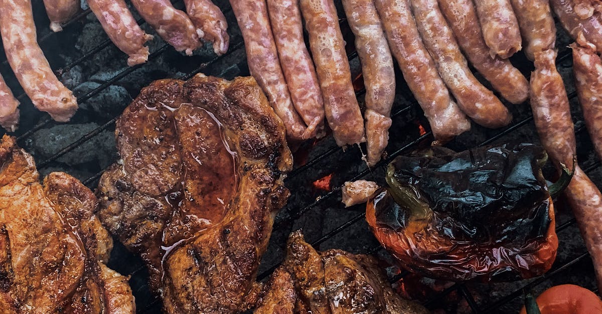 Can I bring nuts and cooked sausage from Brazil to Germany? - From above yummy steaks and meat sausages roasting on grill grid near organic capsicum during picnic