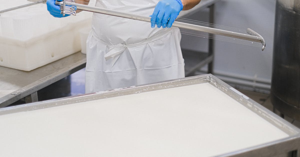 Can I bring Swiss cheese into Canada? - Person in White Scrub Suit Holding Blue and White Stick