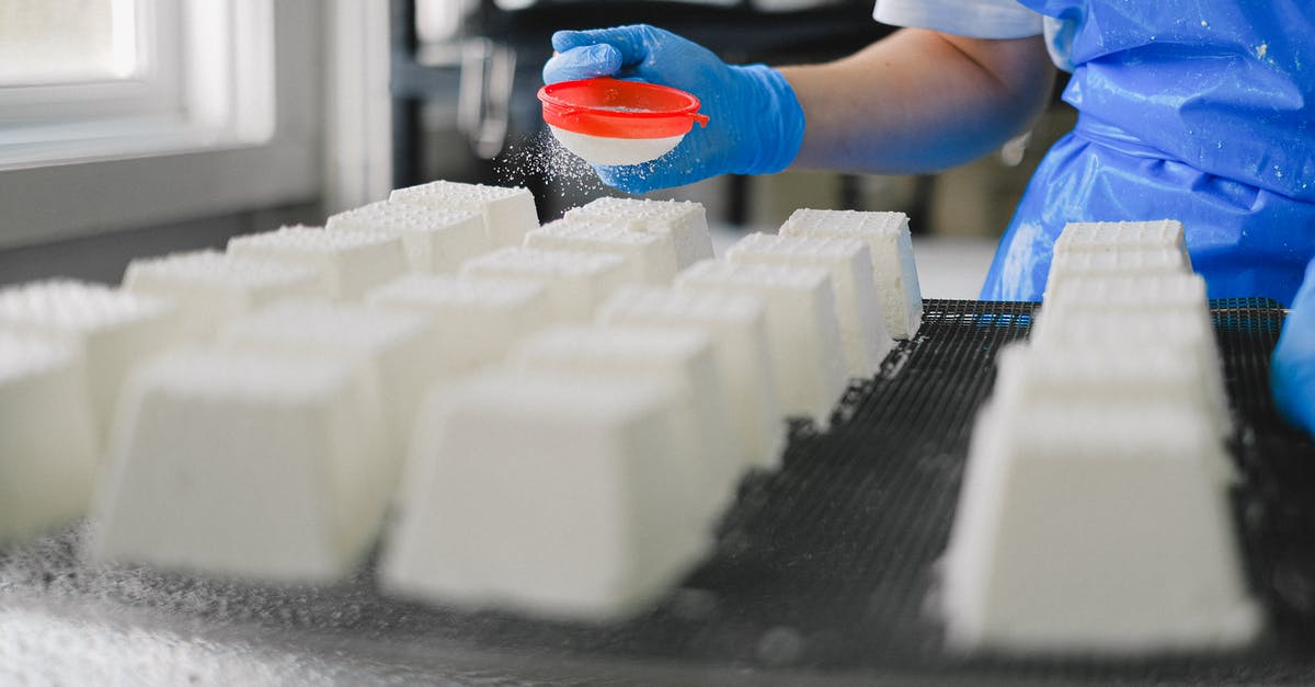 Can I bring Swiss cheese into Canada? - Close Up of Person Working in Cheese Factory