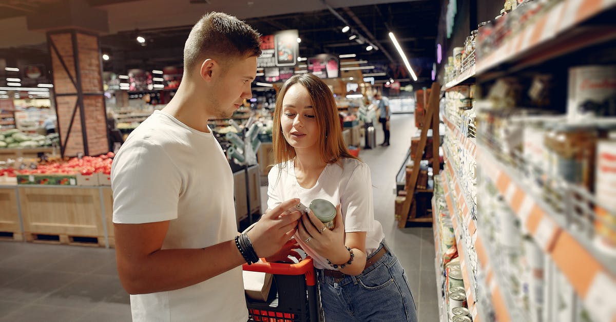 Can I buy pressure cookers and mixer grinders in Poland? - Young couple selecting food in market