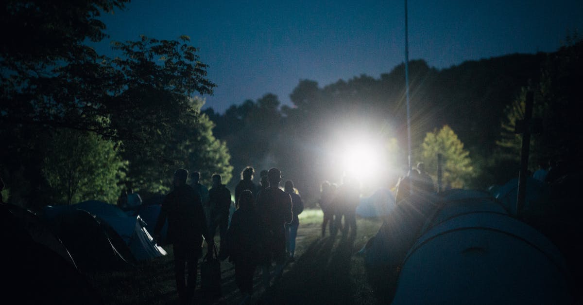 Can I camp on a campsite under 18 in Italy? - People Standing Near Tent during Night Time