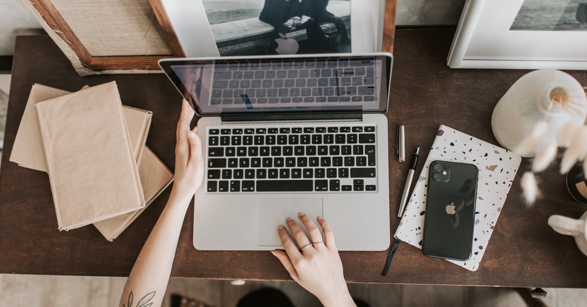 Can I carry used computer parts from India to Germany - Unrecognizable lady using laptop in workspace