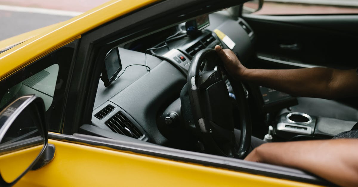 Can I check in all the way through? - Ethnic man driving taxi equipped with navigator