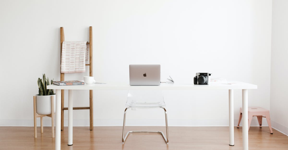 Can I check in at a desk (JFK) from inside security? - Silver MacBook on White Table