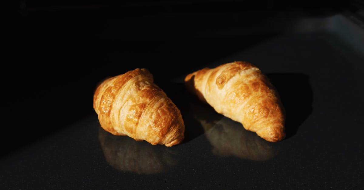 Can I combine two French stamps? - Pair of fresh yummy croissants on black glass surface